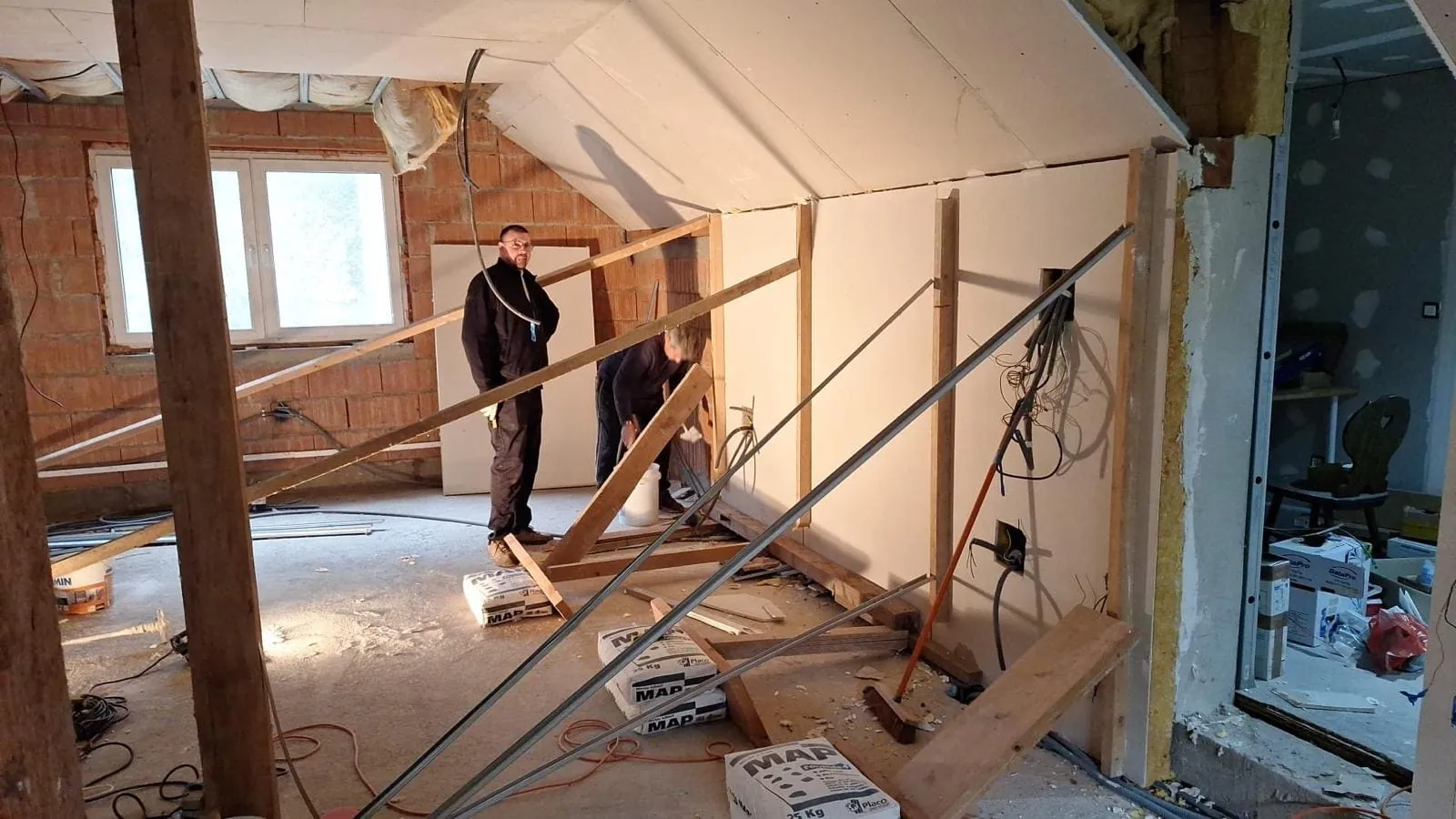 Pièce en chantier avec placoplâtre, isolation et structure bois — aménagement intérieur